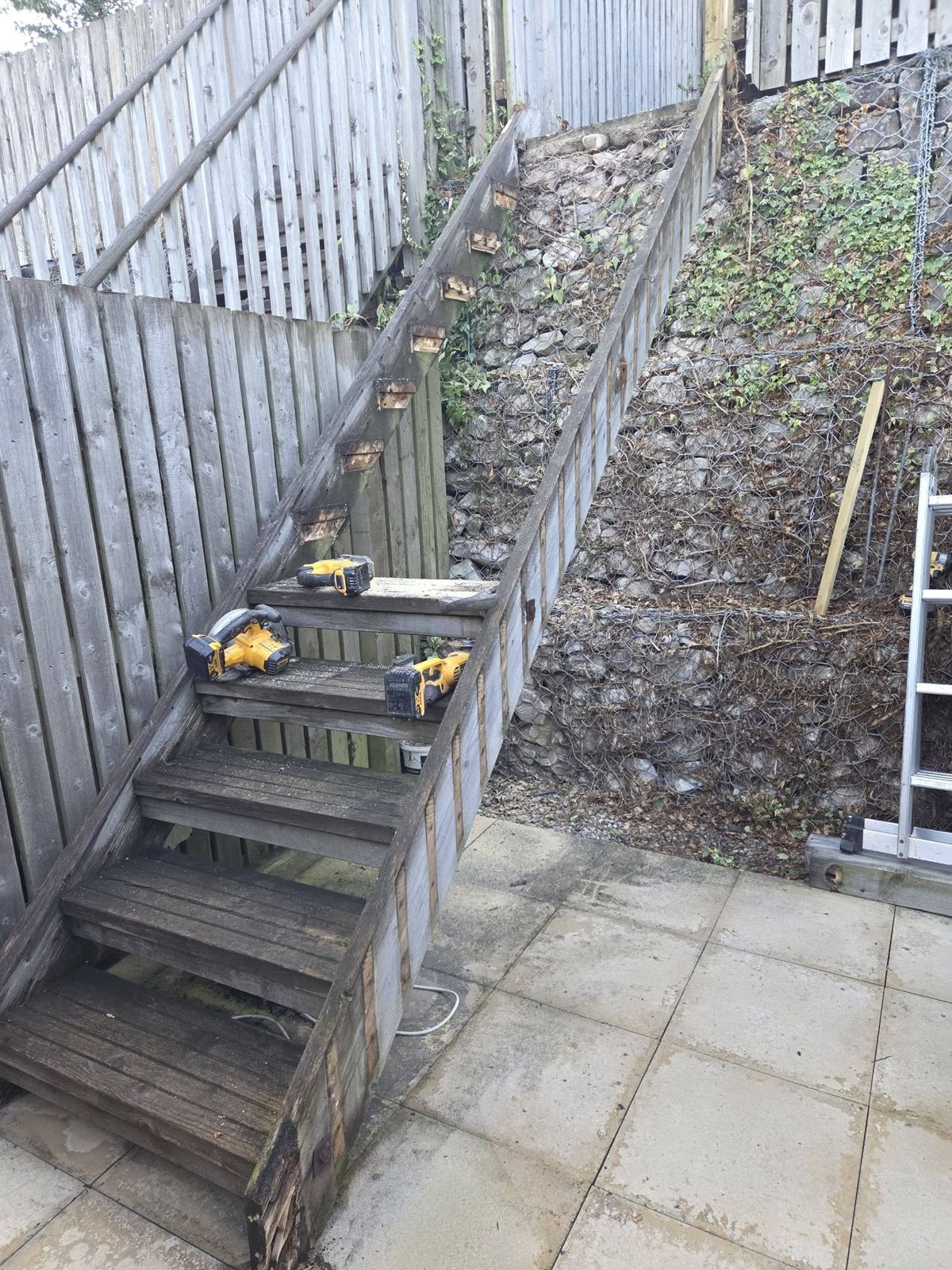 Old weathered timber steps up a steep garden bank