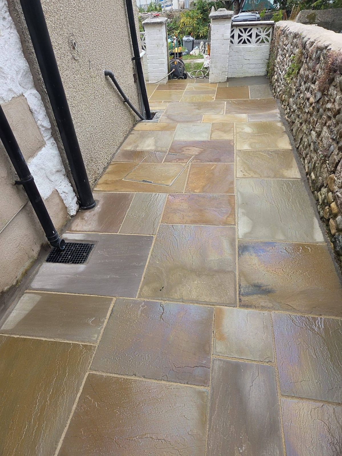 New sandstone patio laid along the side passage