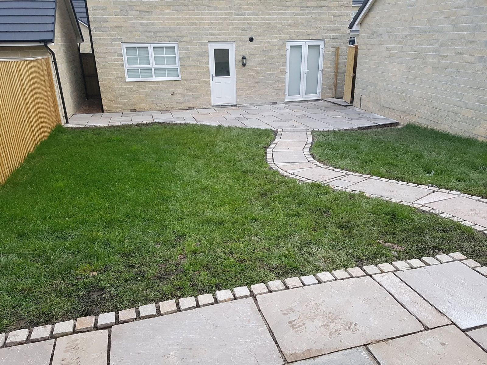 Finished garden with lawn, curved path, patio and closeboard fencing