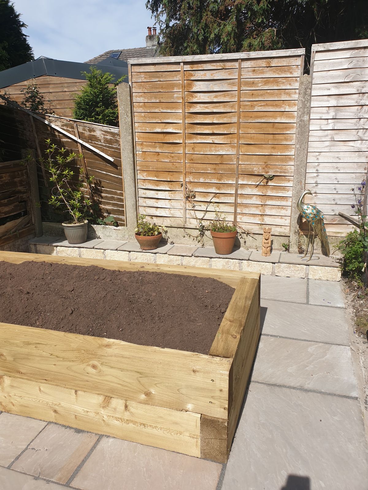 Timber sleeper raised bed on a new stone patio
